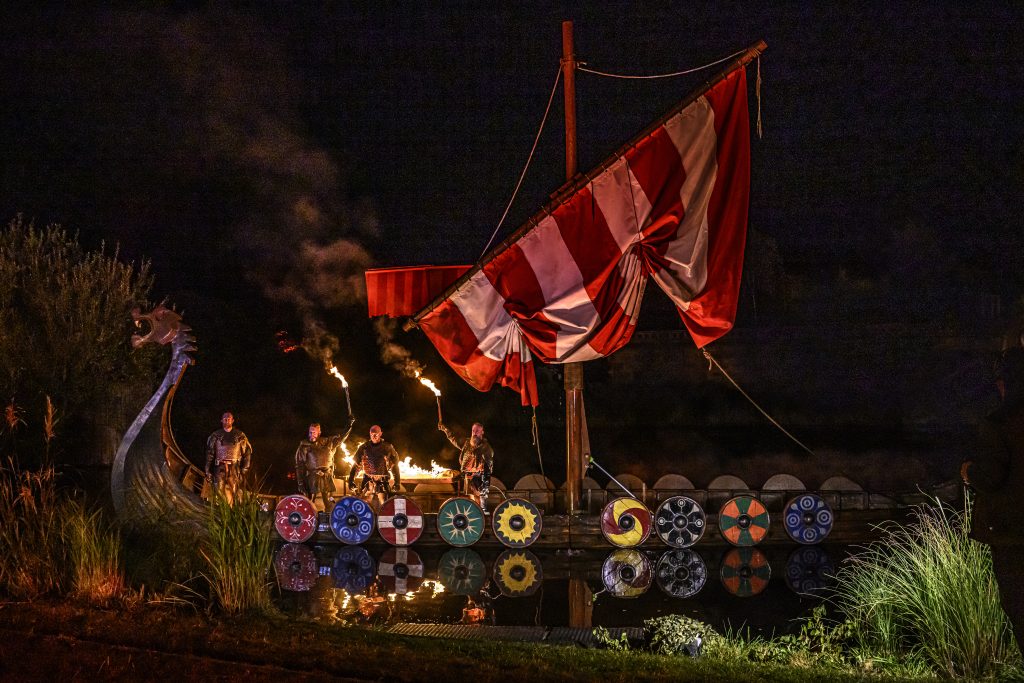 Viking ship illuminated by fire during Kynren – An Epic Tale of England's evening spectacular.